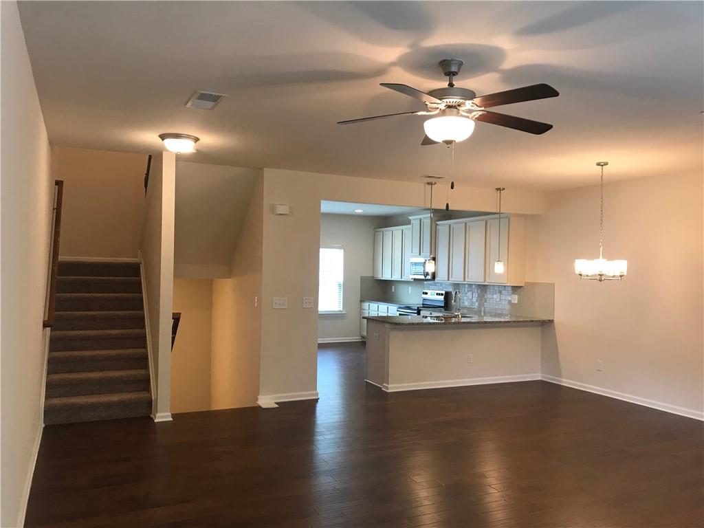 3844 Equity Lane Powder Springs, GA 30127 - Photo 6 of 38 a view of a kitchen with wooden floor and a ceiling fan