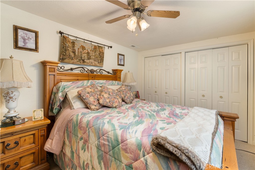 10311 Redwood Road Middletown, CA 95461 - Photo 15 of 48 a bedroom with a bed and a chandelier