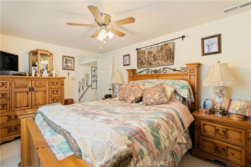 10311 Redwood Road Middletown, CA 95461 - Photo 16 of 48 a bedroom with a bed and a chandelier