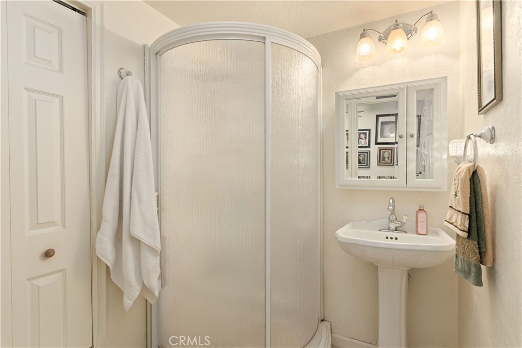 10311 Redwood Road Middletown, CA 95461 - Photo 17 of 48 a bathroom with a sink a mirror and a shower