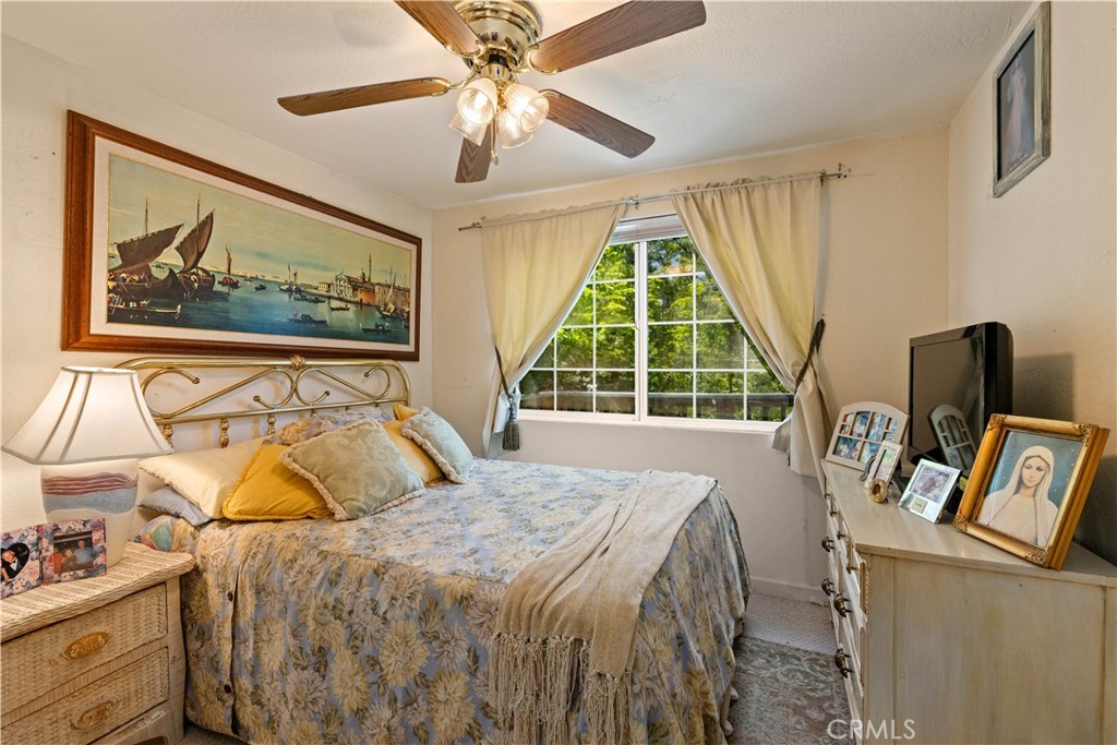 10311 Redwood Road Middletown, CA 95461 - Photo 19 of 48 a bed sitting in a bedroom next to a window