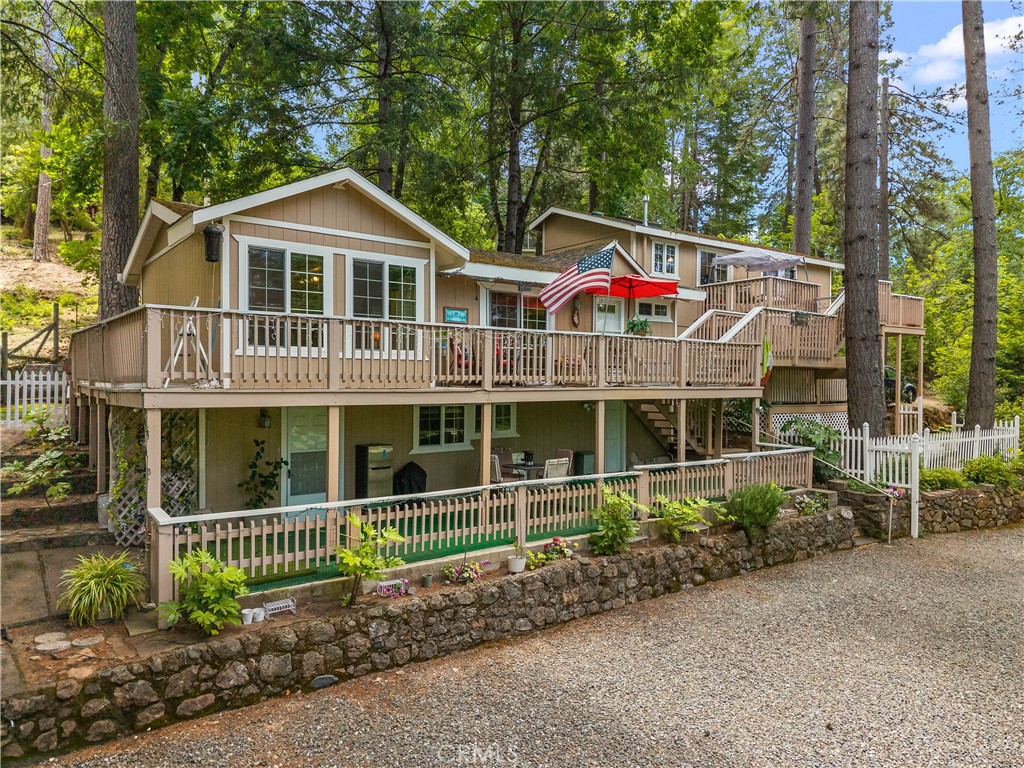 10311 Redwood Road Middletown, CA 95461 - Photo 25 of 48 a front view of a house with a garden and plants