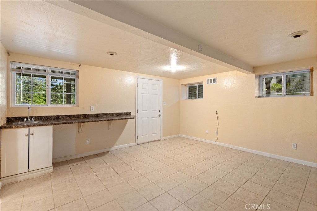 10311 Redwood Road Middletown, CA 95461 - Photo 30 of 48 a view of an empty room with wooden floor and a window