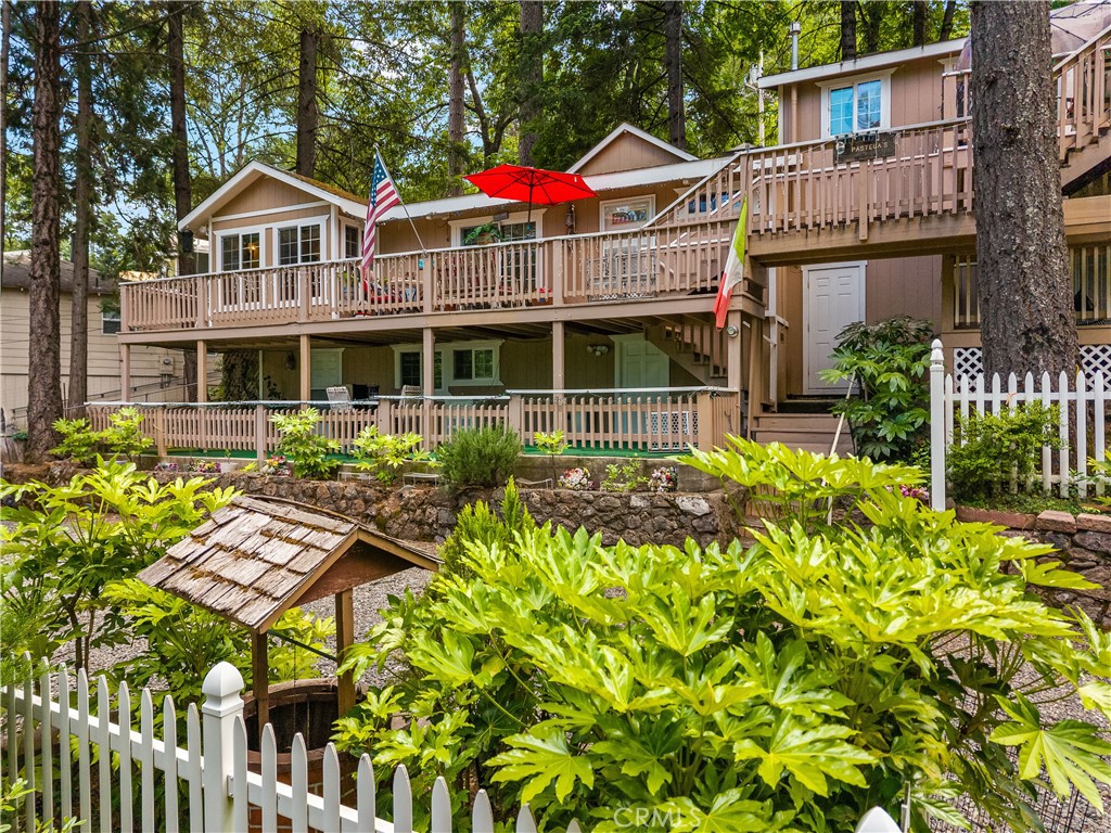 10311 Redwood Road Middletown, CA 95461 - Photo 34 of 48 a front view of a house with a yard and potted plants
