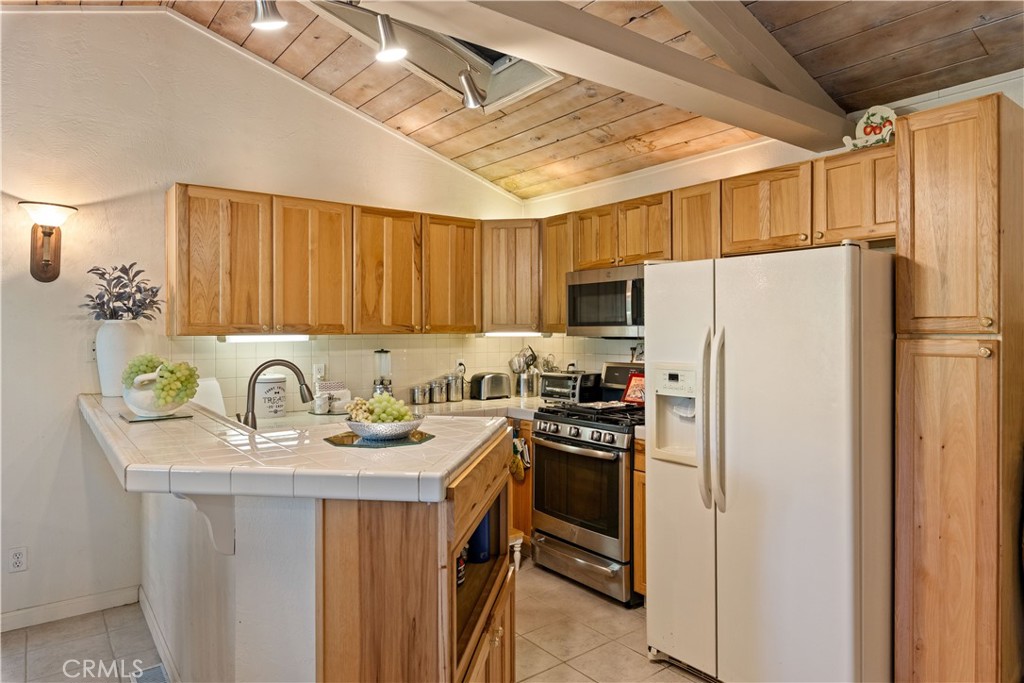 10311 Redwood Road Middletown, CA 95461 - Photo 5 of 48 a kitchen with stainless steel appliances granite countertop a refrigerator a sink a stove a dining table and chairs