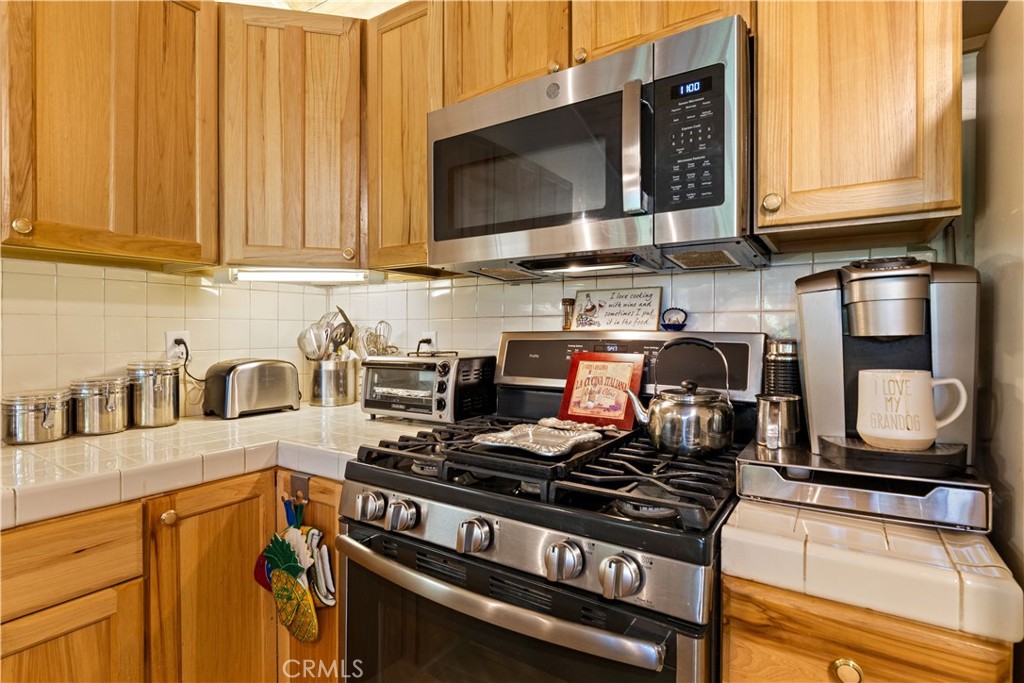 10311 Redwood Road Middletown, CA 95461 - Photo 6 of 48 a kitchen with stainless steel appliances granite countertop a stove and a microwave