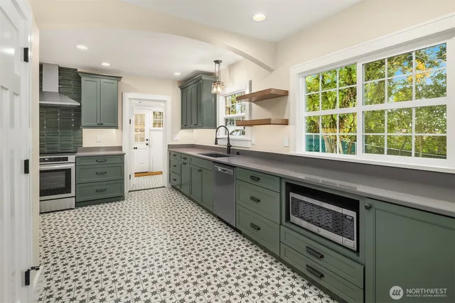 a kitchen with a sink stove and cabinets