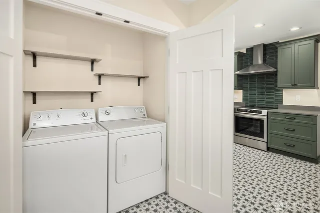 a view of a storage & utility room with dryer and washer