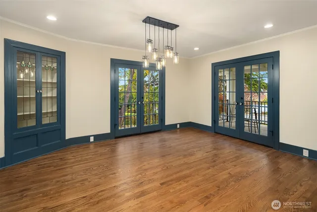 a view of an empty room with glass door and a window