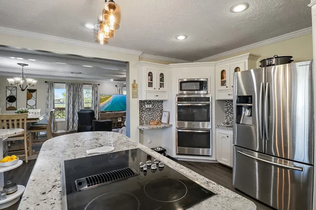 a kitchen with a refrigerator and a sink