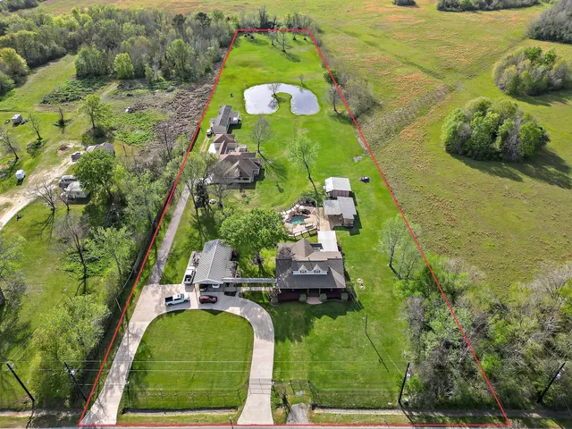 an aerial view of a house with a yard basket ball court and outdoor seating
