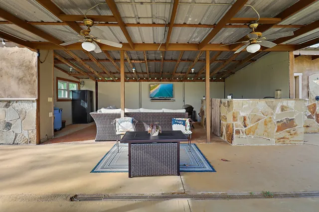 a view of a patio with a table and chairs