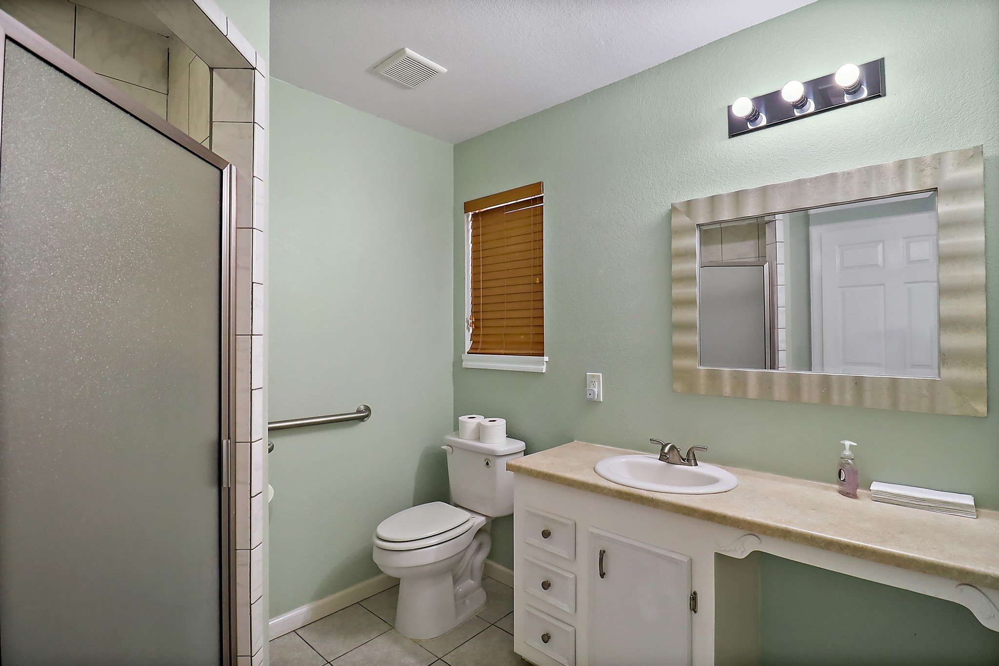 15321 Lindstrom Road Crosby, TX 77532 - Photo 43 of 50 a bathroom with a toilet sink and mirror