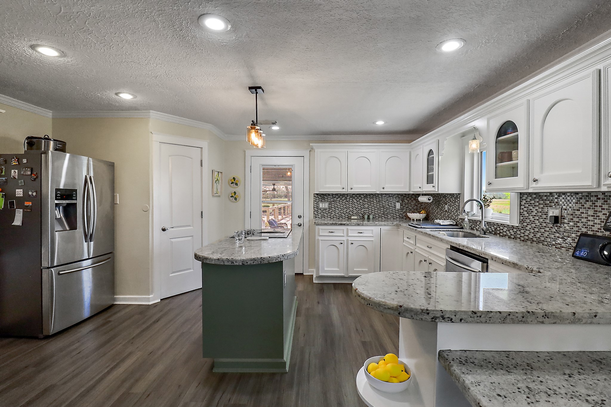 15321 Lindstrom Road Crosby, TX 77532 - Photo 10 of 50 a kitchen with stainless steel appliances granite countertop a refrigerator a sink dishwasher a stove and a refrigerator with wooden floor