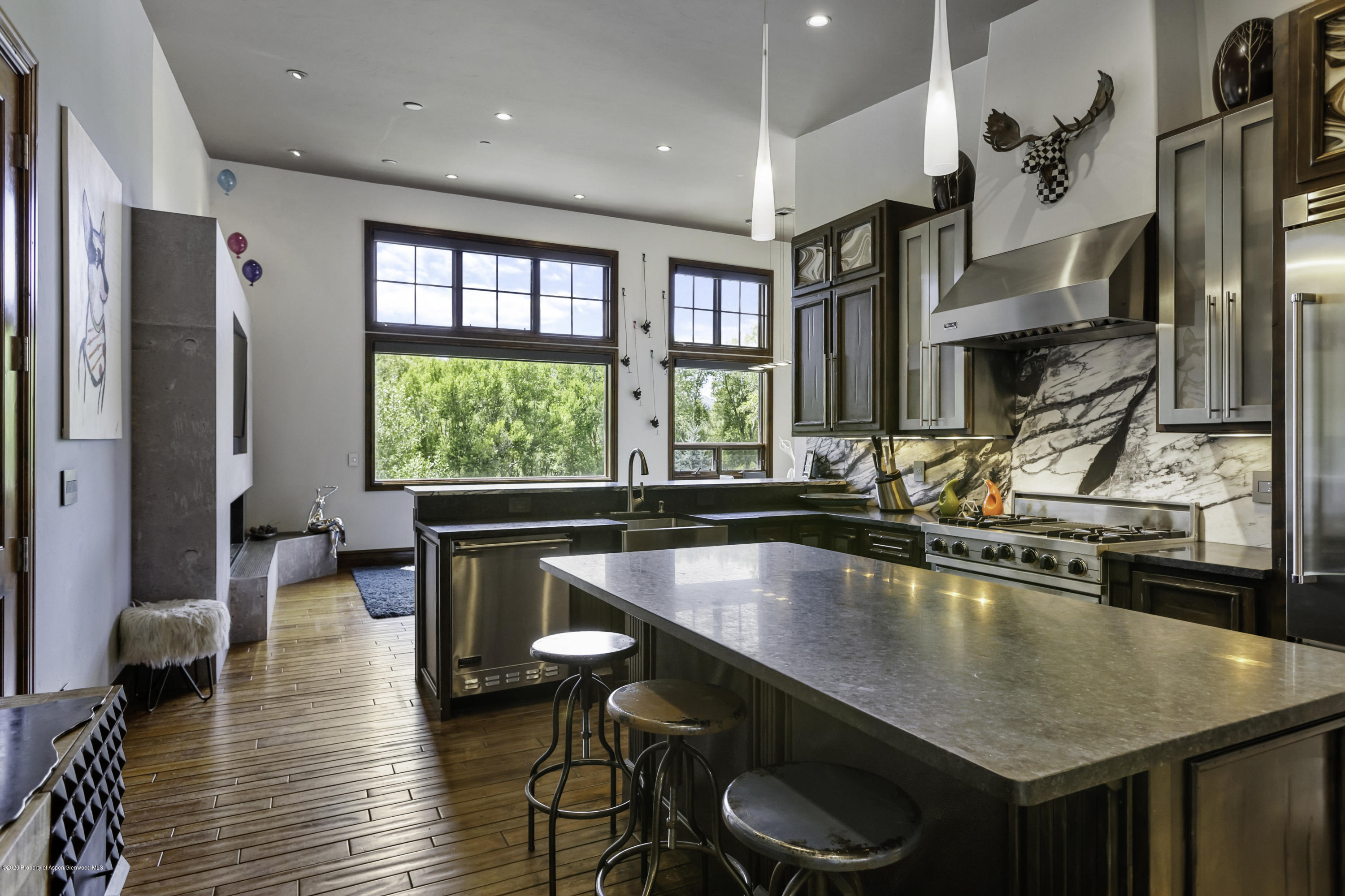 a kitchen with stainless steel appliances granite countertop a stove a sink and a refrigerator