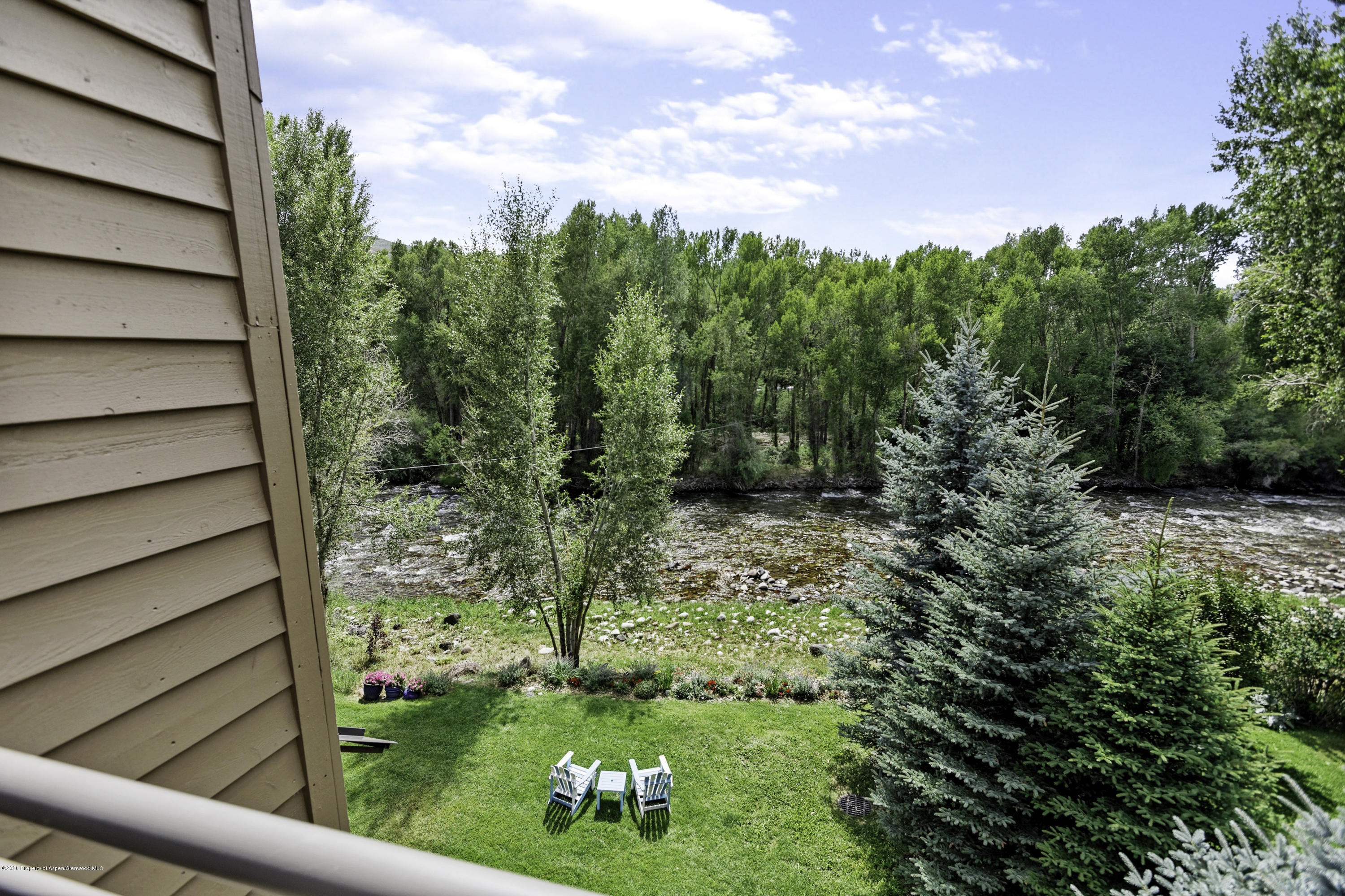 23272 2 Rivers Road, Unit 301 Basalt, CO 81621 - Photo 12 of 16 a view of a yard with plants and wooden fence
