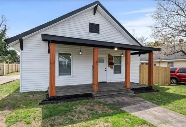 a front view of house with a garden