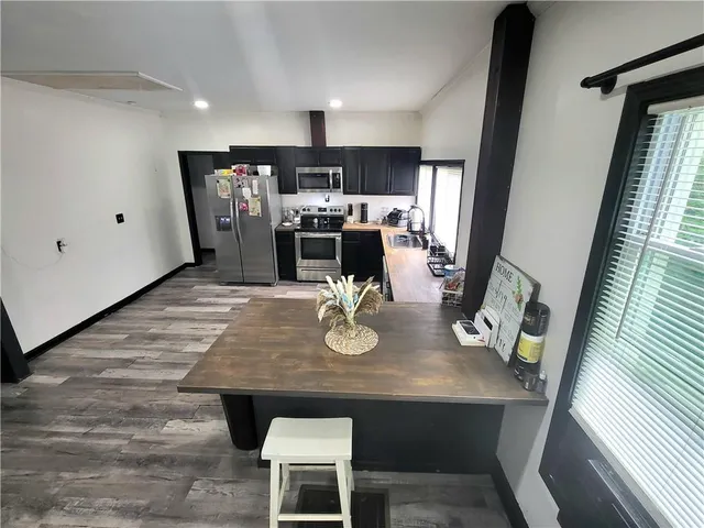 a dining room with furniture and wooden floor