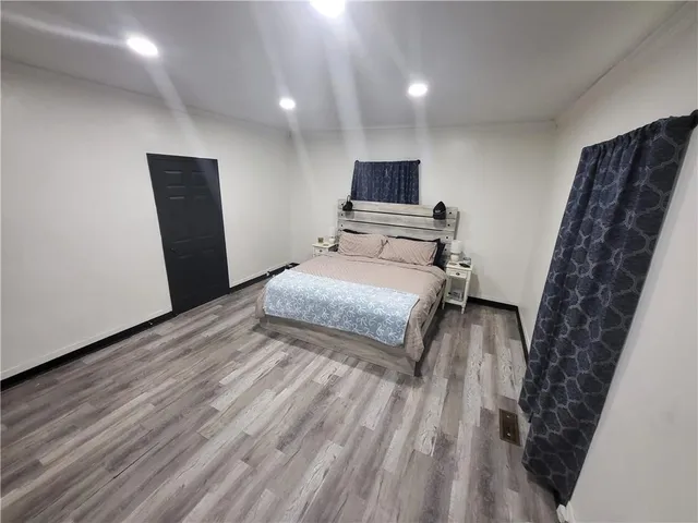 a bedroom with a bed and a large mirror
