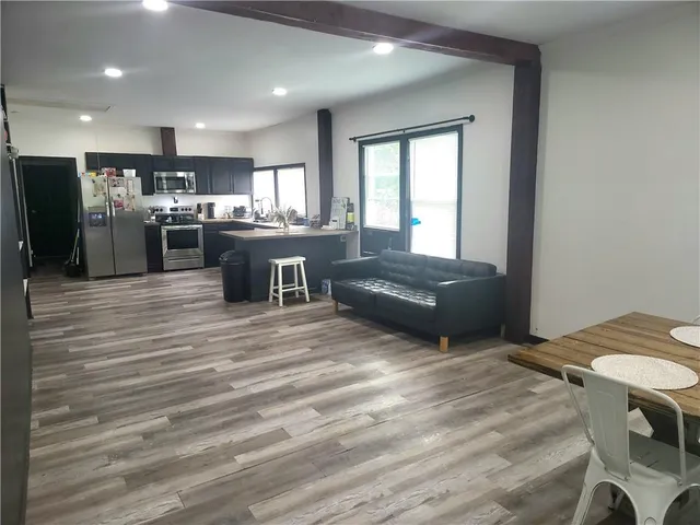a kitchen with a refrigerator and a sink