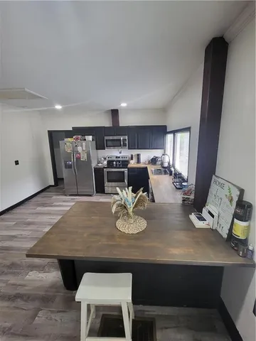 a dining room with furniture and wooden floor