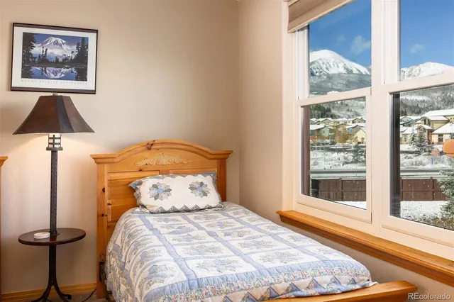 a bedroom with a bed and a painting on the wall