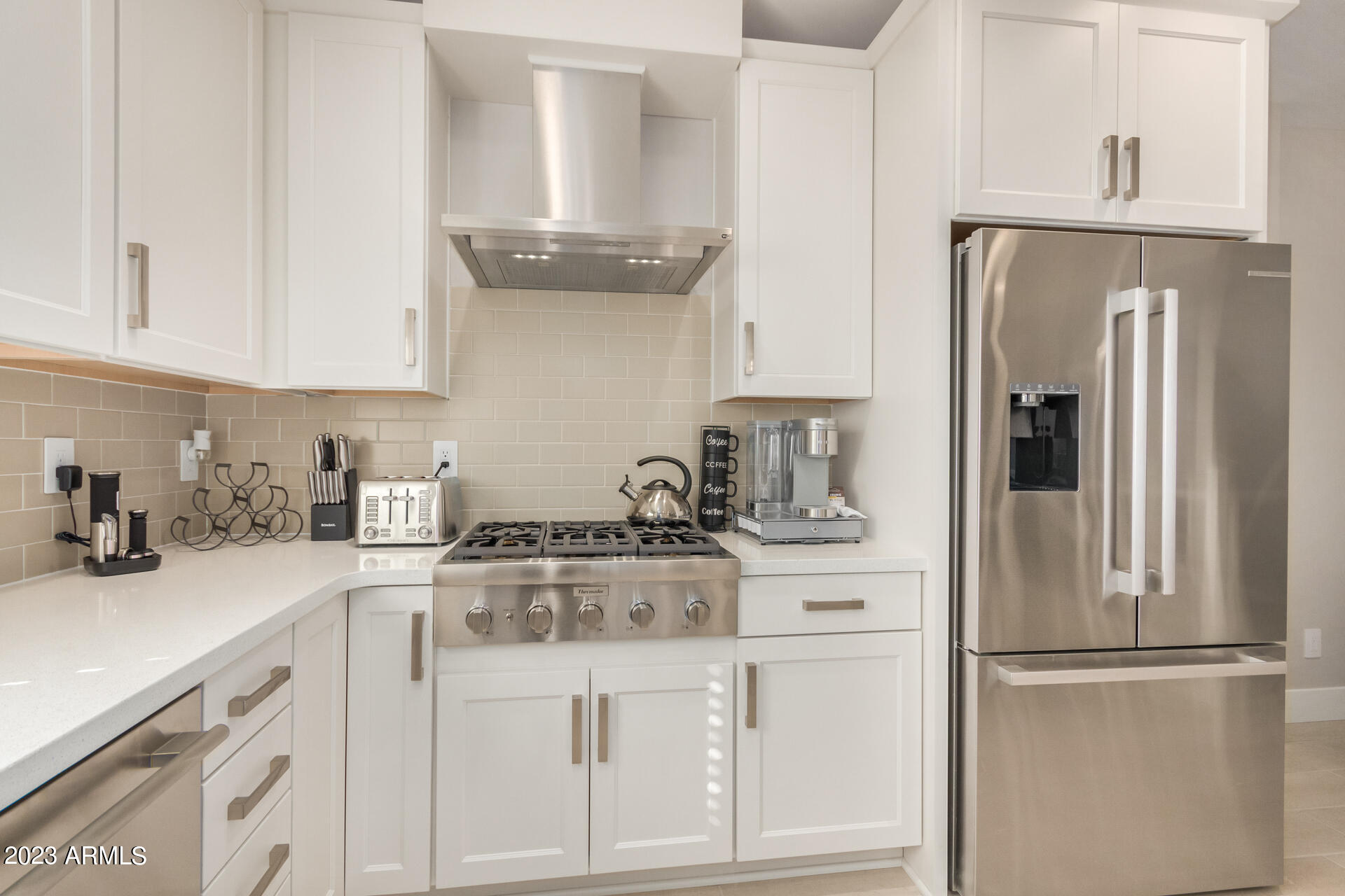 7550 East Osborn Road, Unit 1009 Scottsdale, AZ 85251 - Photo 20 of 39 a kitchen with stainless steel appliances granite countertop white cabinets and a refrigerator