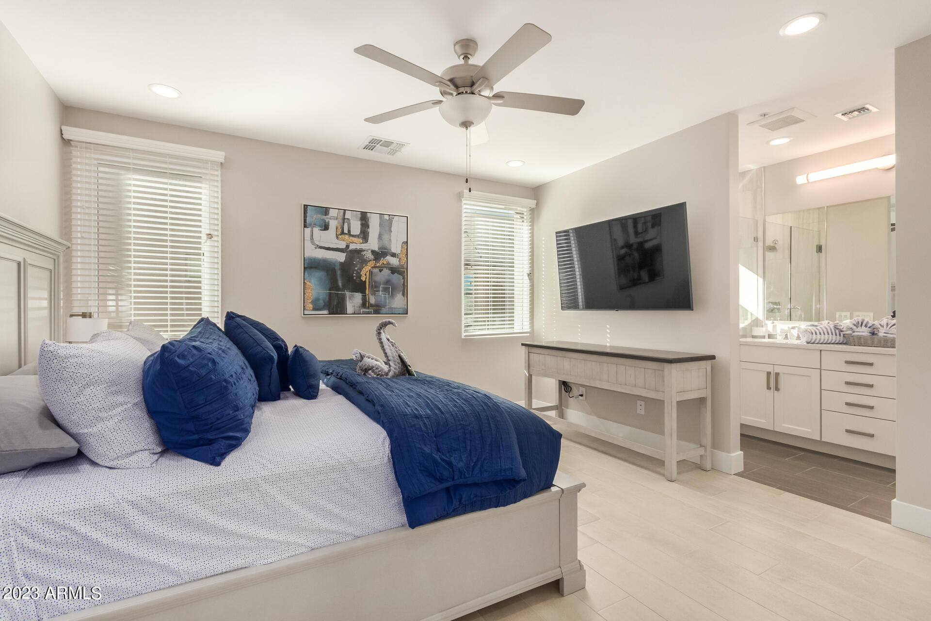 7550 East Osborn Road, Unit 1009 Scottsdale, AZ 85251 - Photo 25 of 39 a spacious bedroom with a large bed and a flat screen tv
