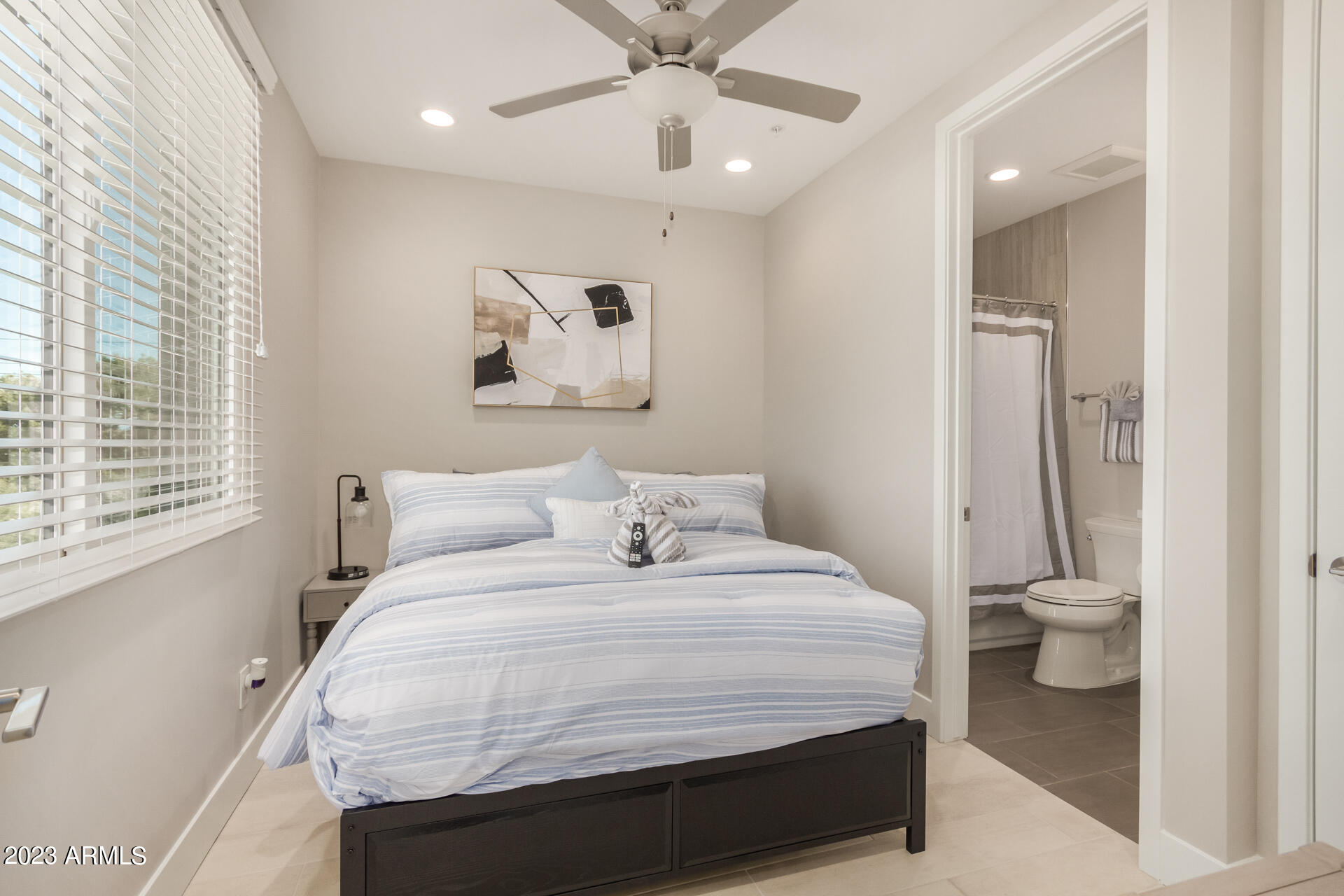 7550 East Osborn Road, Unit 1009 Scottsdale, AZ 85251 - Photo 29 of 39 a bedroom with a bed and a window