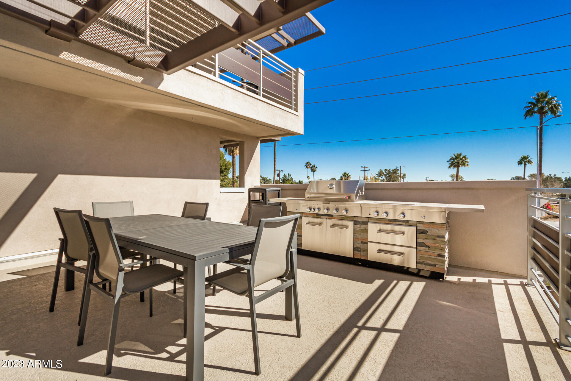 7550 East Osborn Road, Unit 1009 Scottsdale, AZ 85251 - Photo 38 of 39 a patio with a table and chairs