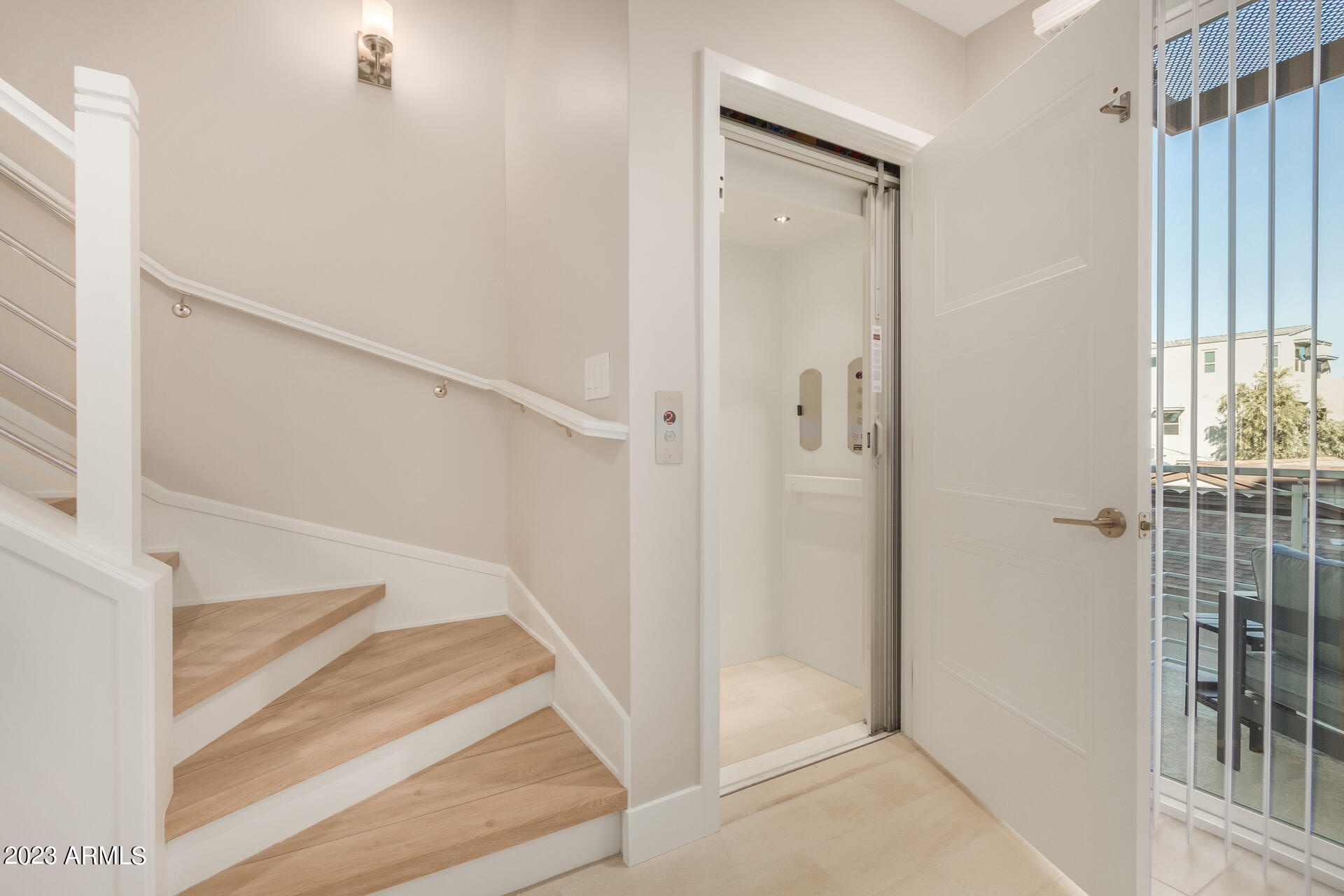 7550 East Osborn Road, Unit 1009 Scottsdale, AZ 85251 - Photo 6 of 39 a view of staircase with white walls and windows