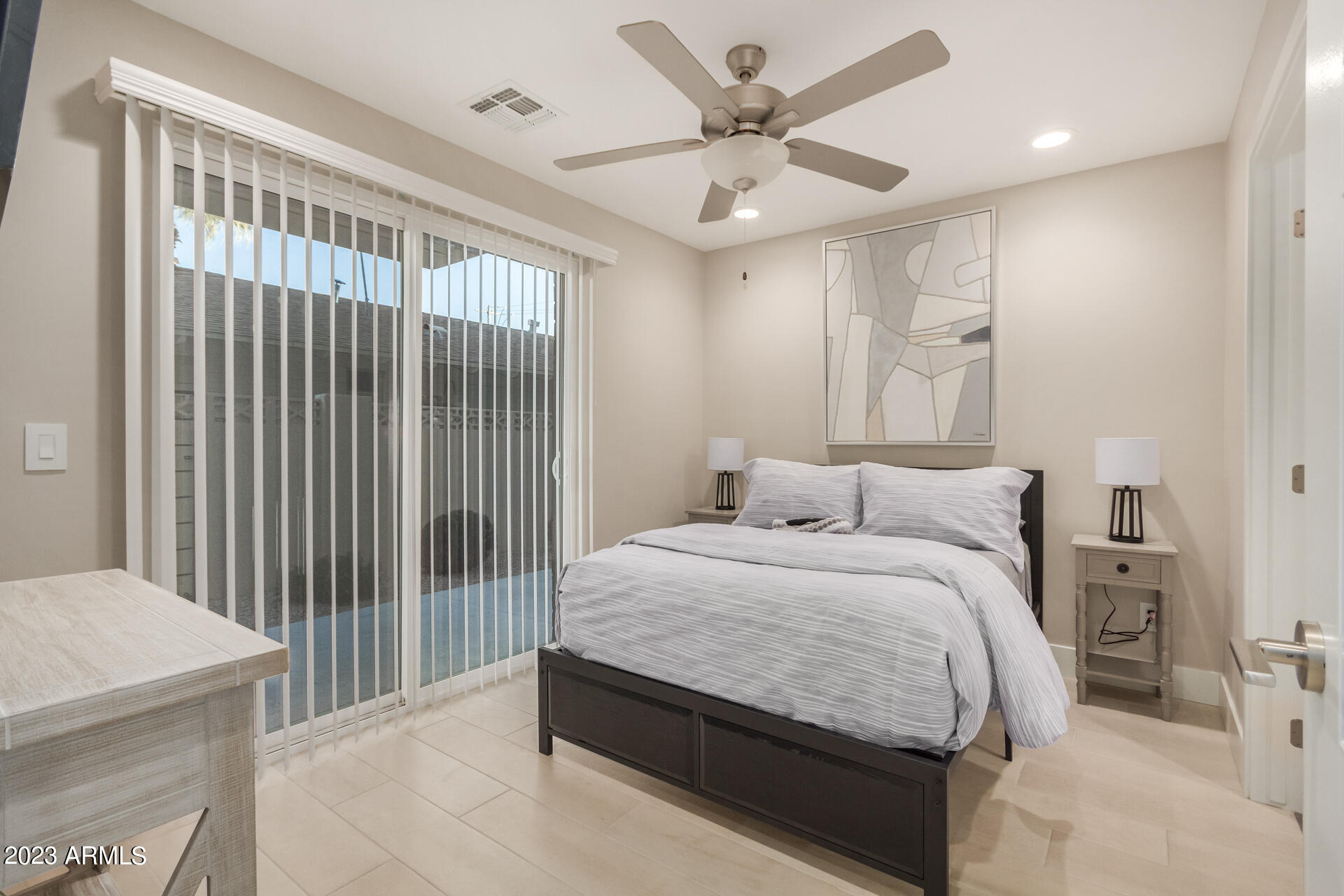 7550 East Osborn Road, Unit 1009 Scottsdale, AZ 85251 - Photo 7 of 39 a spacious bedroom with a bed and a chandelier