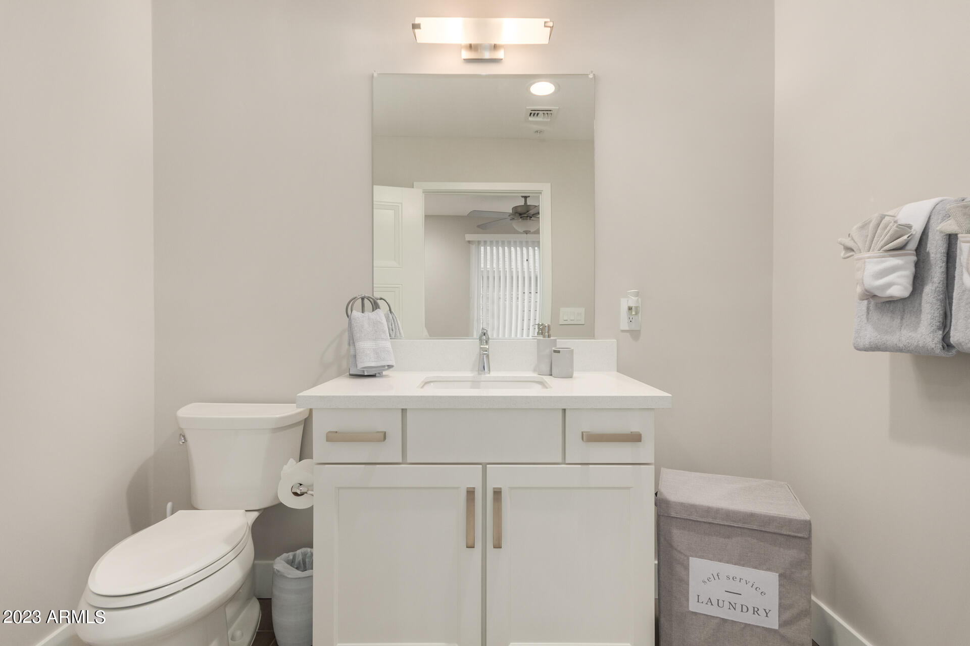 7550 East Osborn Road, Unit 1009 Scottsdale, AZ 85251 - Photo 9 of 39 a view of bathroom with a sink mirror and toilet