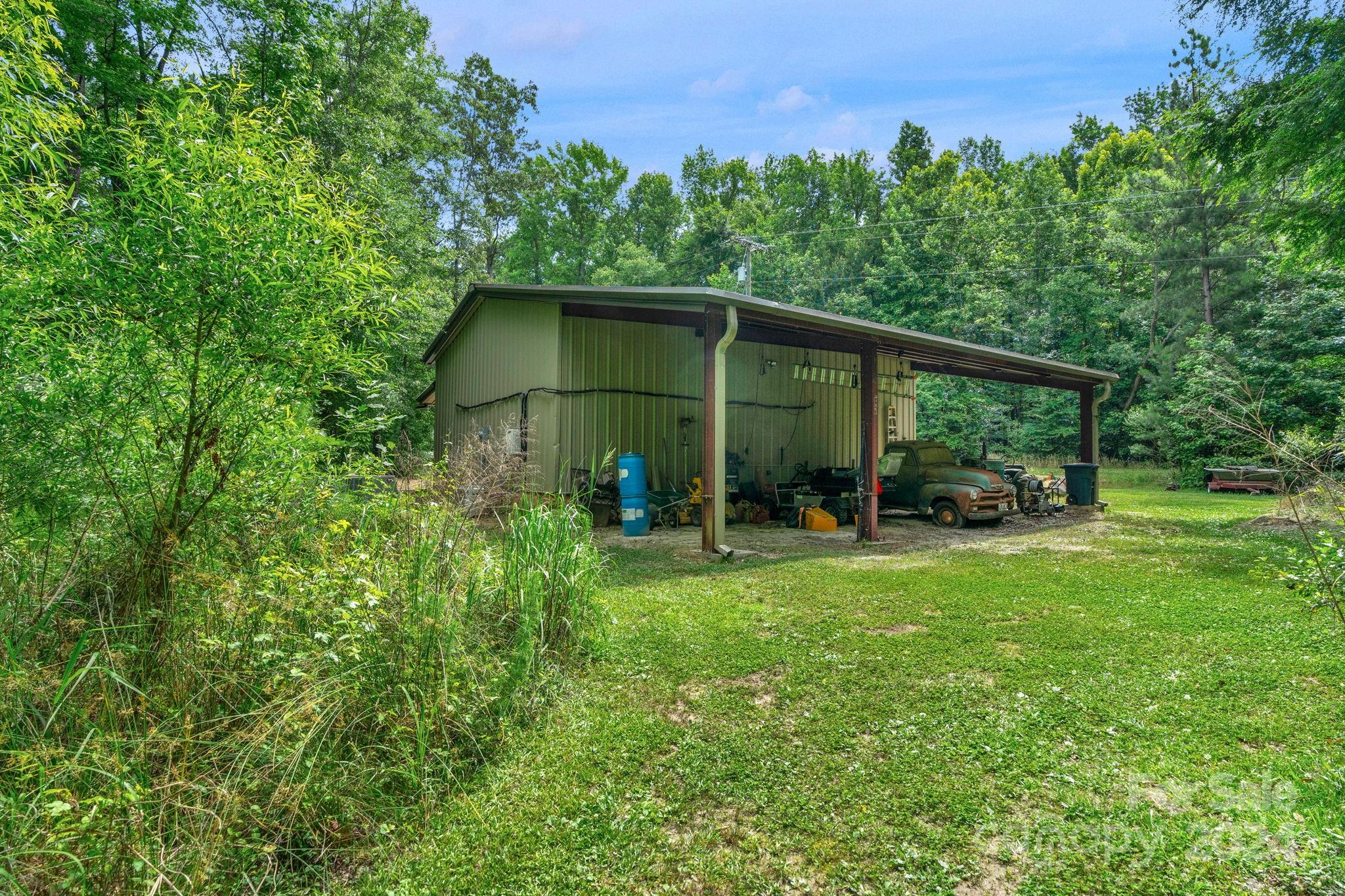 206 Niven Road Lancaster, SC 29720 - Photo 41 of 44 a view of a wooden house with a yard and plants