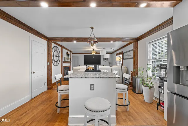 a kitchen with stainless steel appliances granite countertop a stove a sink and a refrigerator