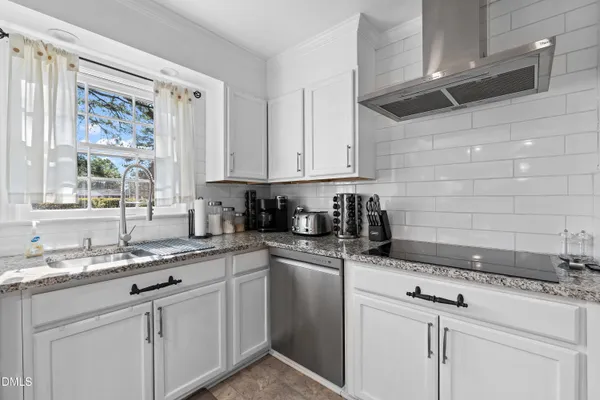 a kitchen with stainless steel appliances granite countertop a refrigerator sink and stove