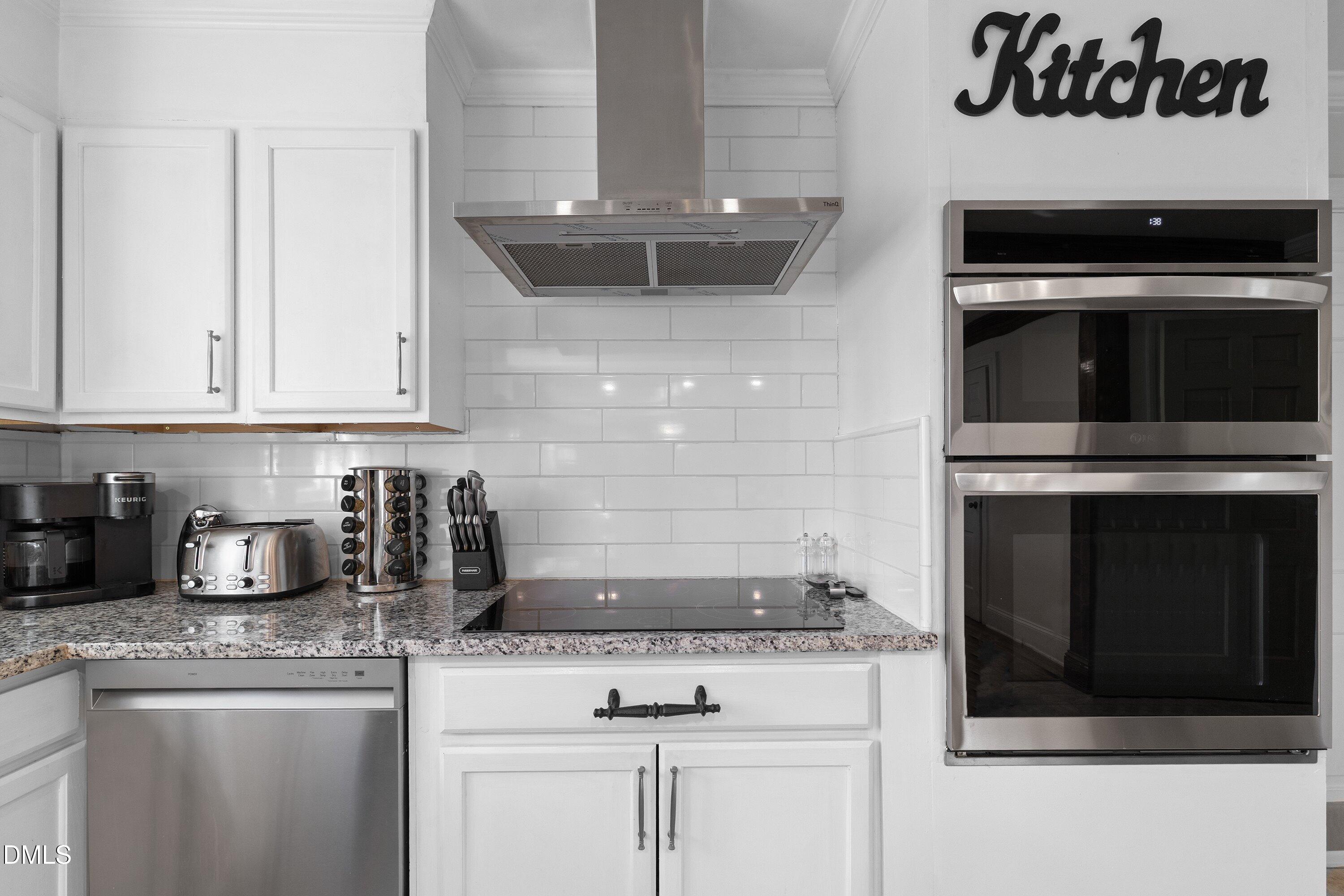 3329 Winstead Road Rocky Mount, NC 27804 - Photo 14 of 37 a kitchen with granite countertop white cabinets and stainless steel appliances
