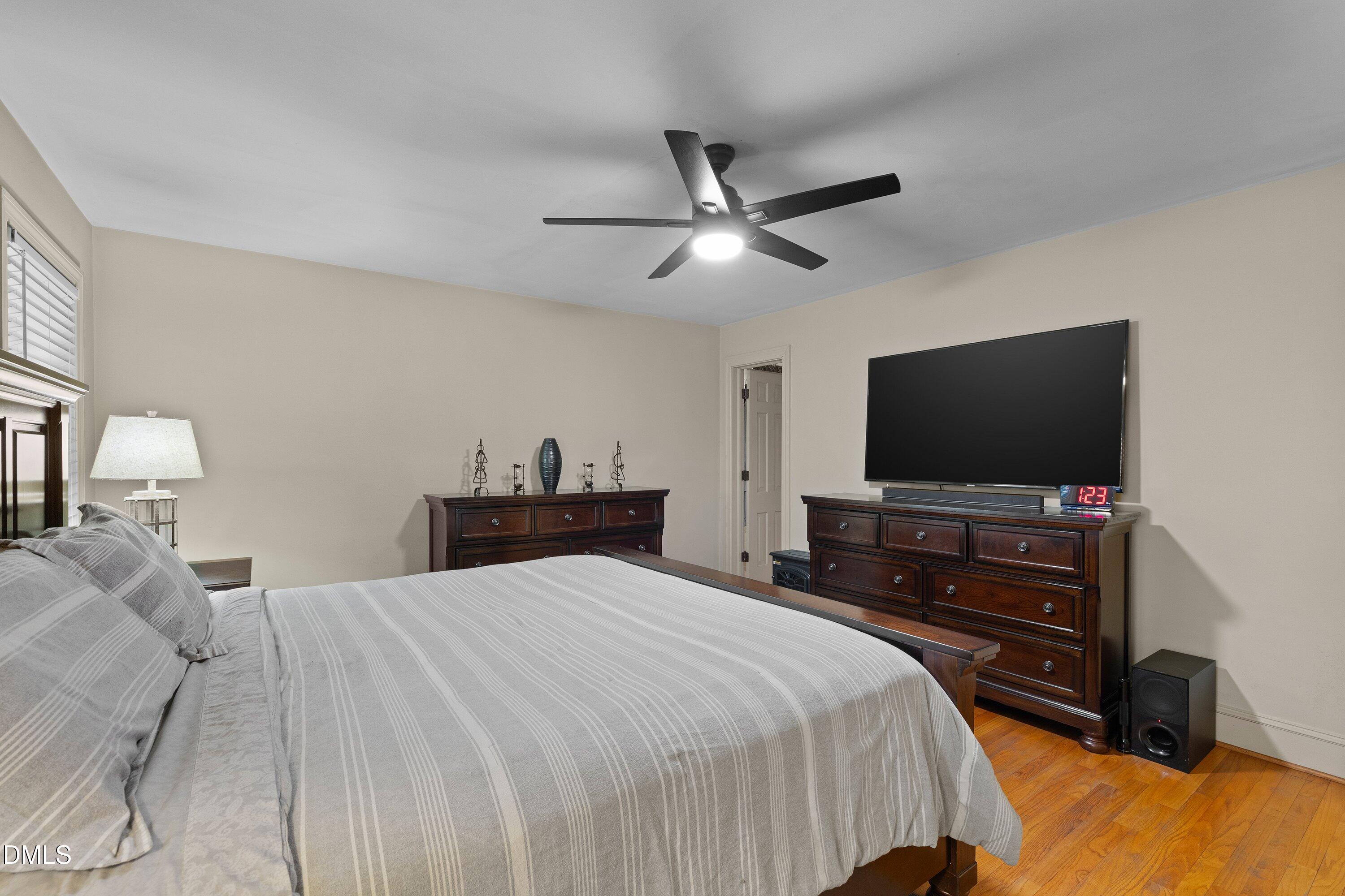 3329 Winstead Road Rocky Mount, NC 27804 - Photo 21 of 37 a bedroom with a bed and a flat tv screen on dresser