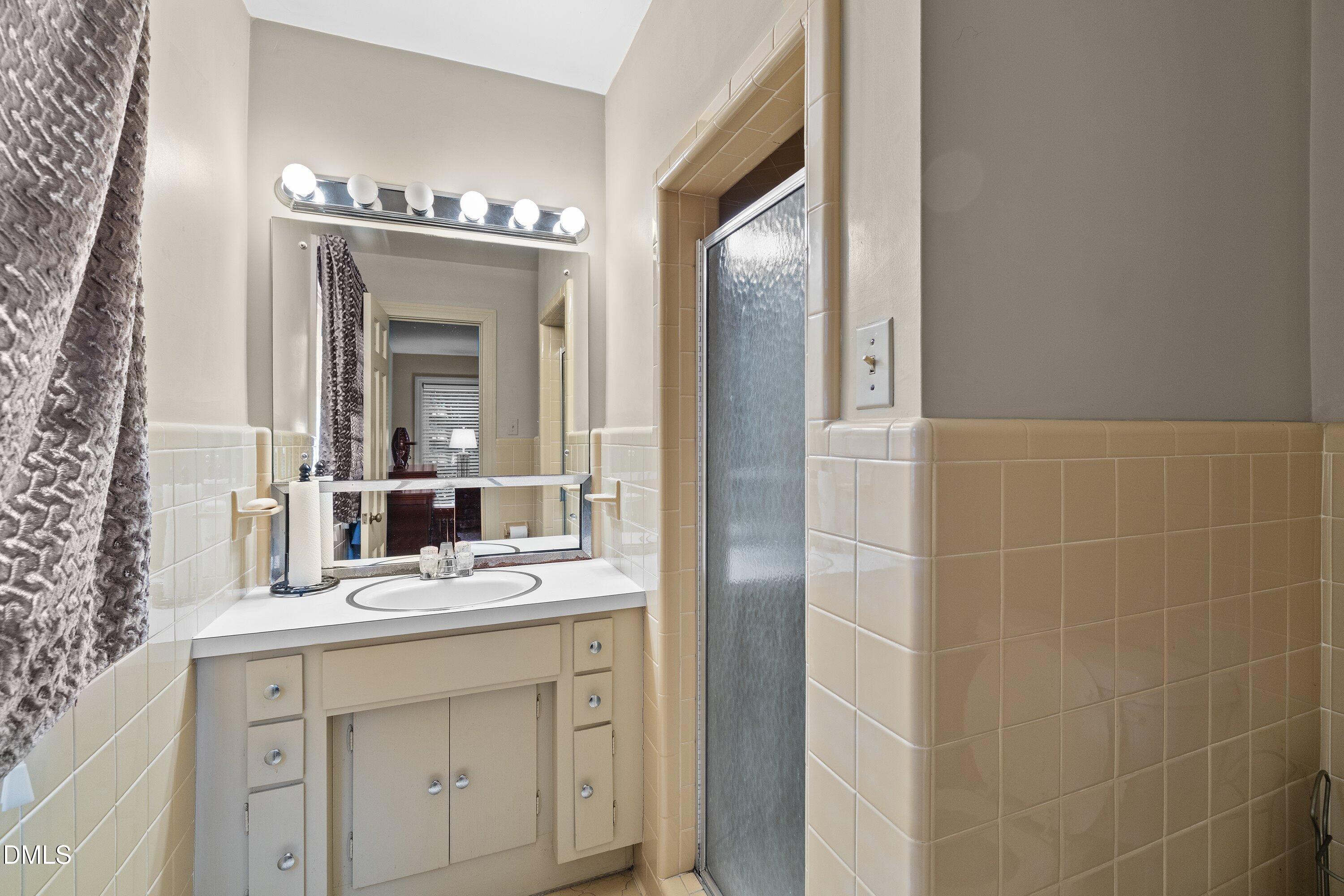 3329 Winstead Road Rocky Mount, NC 27804 - Photo 23 of 37 a bathroom with a double vanity sink and a mirror