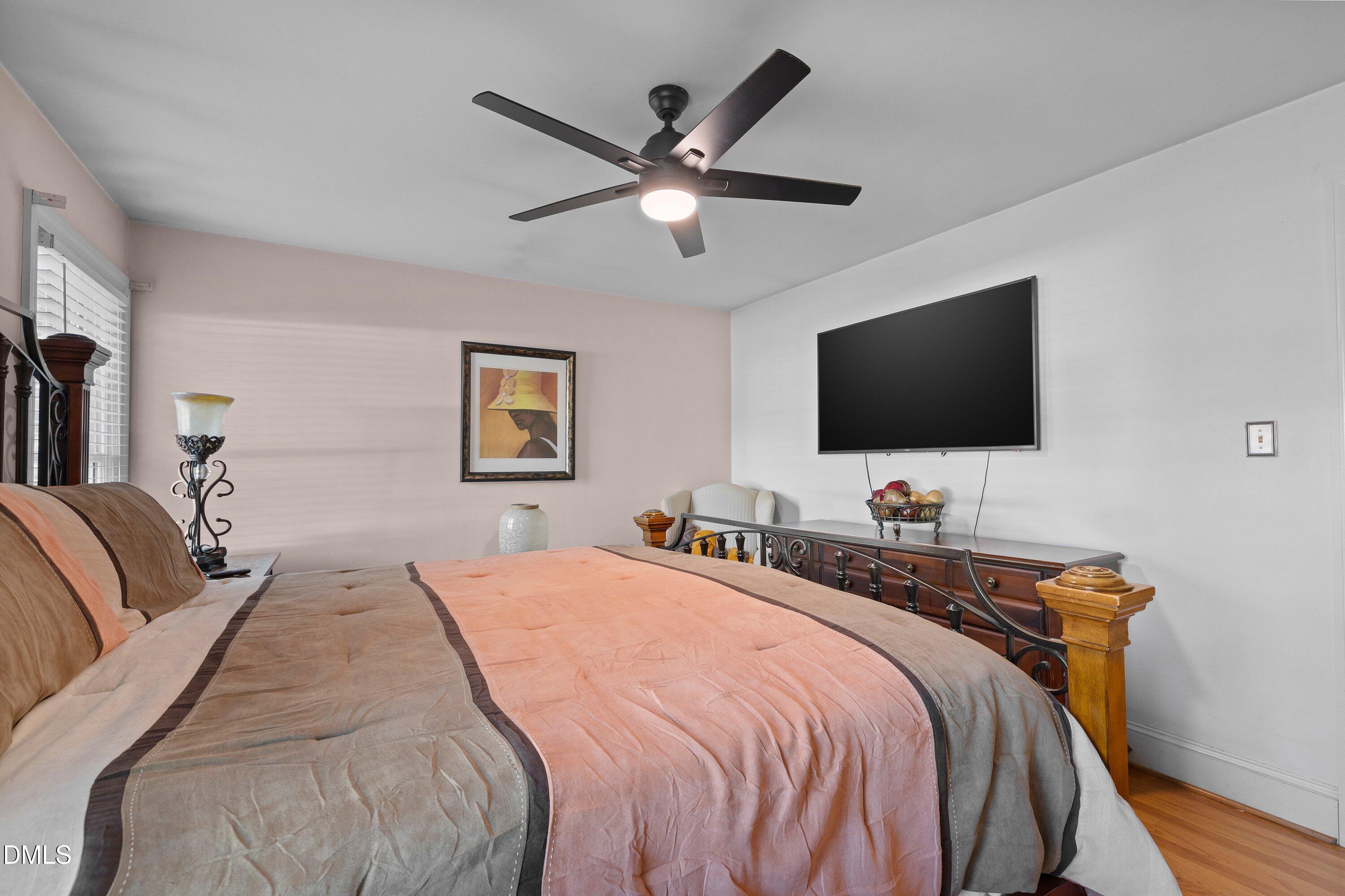 3329 Winstead Road Rocky Mount, NC 27804 - Photo 26 of 37 a bedroom with a bed and a flat screen tv