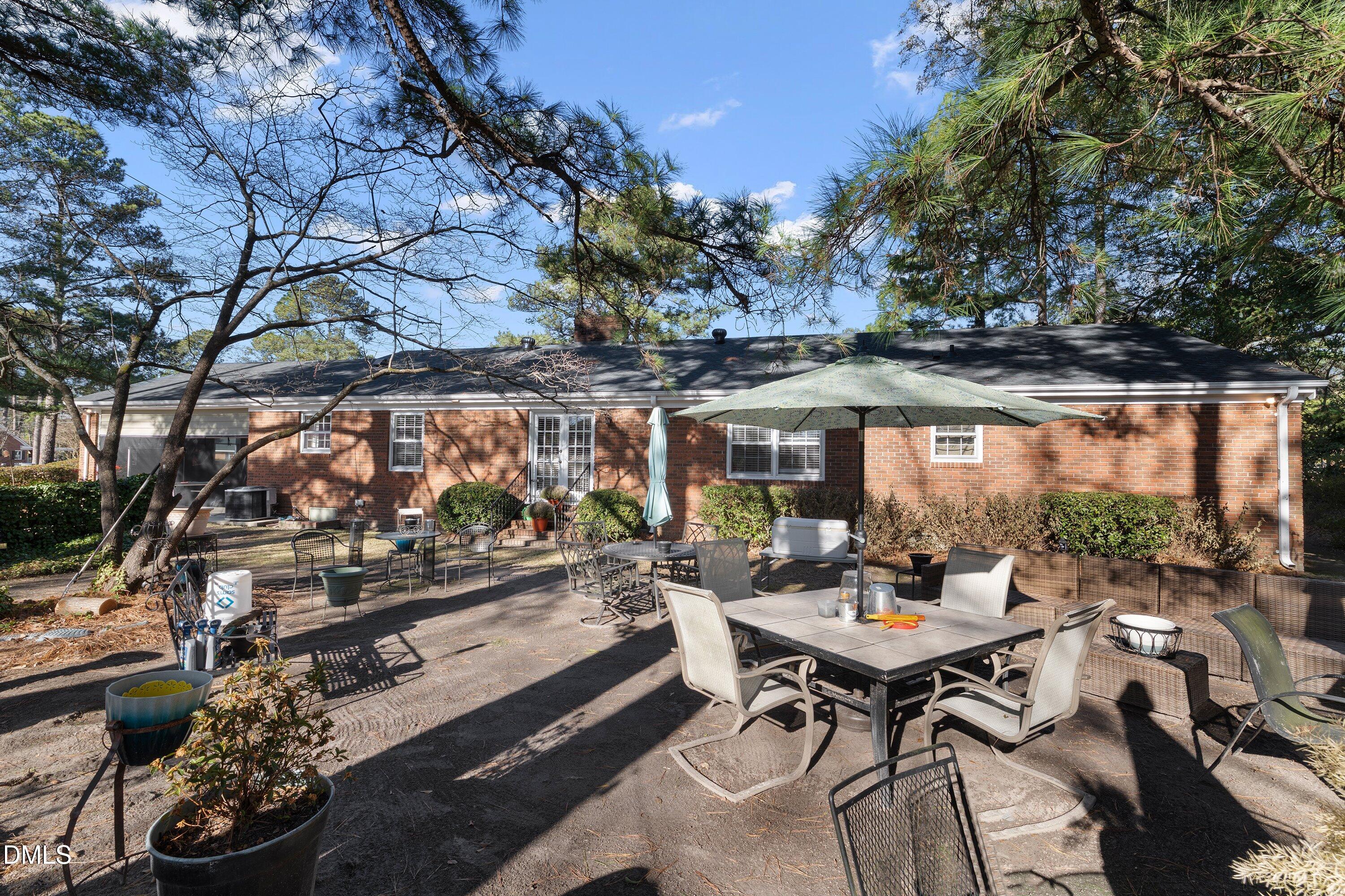3329 Winstead Road Rocky Mount, NC 27804 - Photo 32 of 37 a view of a patio with table and chairs and potted plants