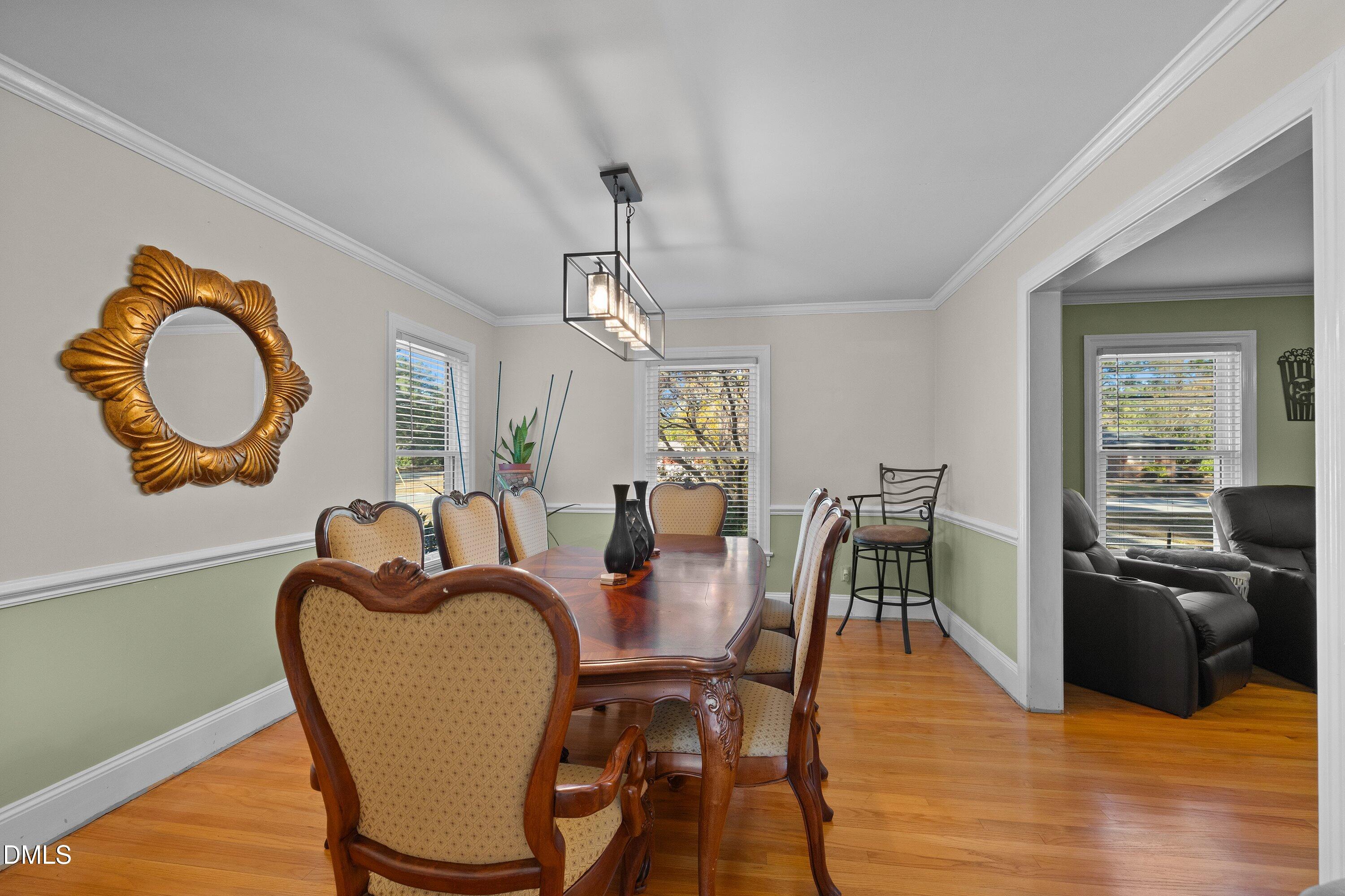3329 Winstead Road Rocky Mount, NC 27804 - Photo 8 of 37 a view of a dining room with furniture and wooden floor