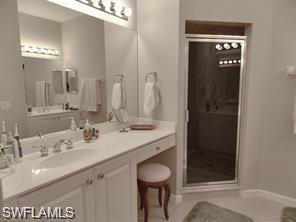 3985 Deer Crossing Court, Unit 201 Naples, FL 34114 - Photo 13 of 24 a bathroom with a sink and a mirror