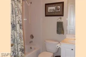 a bathroom with a toilet and a shower curtain
