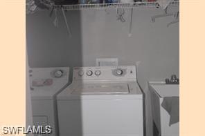 3985 Deer Crossing Court, Unit 201 Naples, FL 34114 - Photo 19 of 24 a utility room with dryer and washer