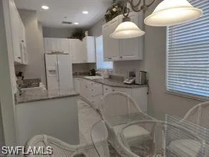 a kitchen with stainless steel appliances granite countertop a sink a refrigerator and a stove