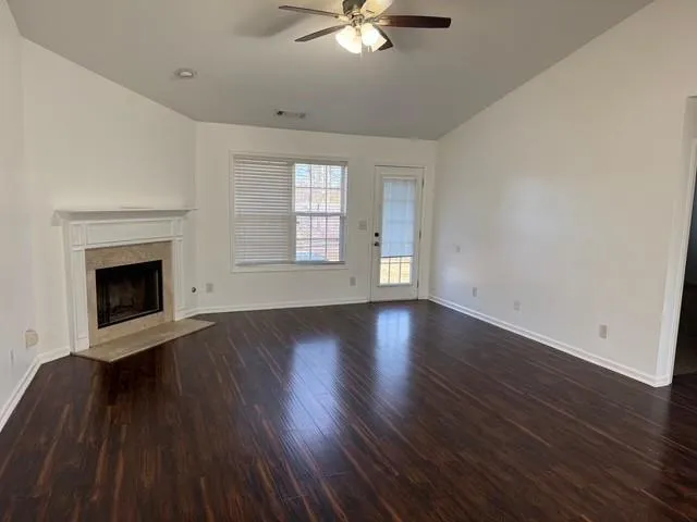 wooden floor fireplace and natural light in room