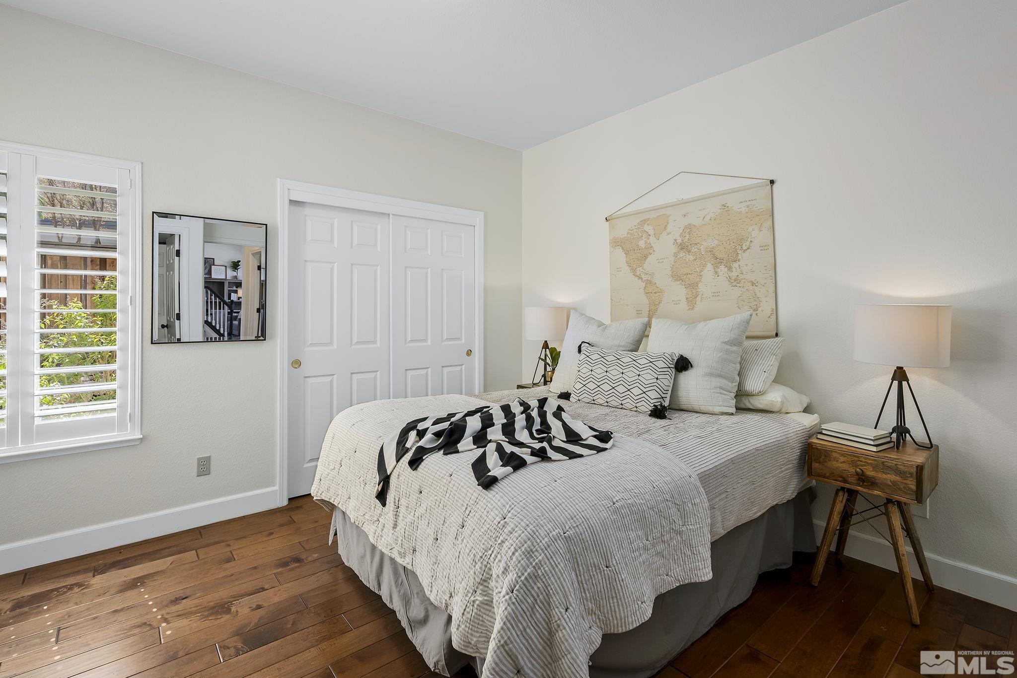 5016 East Albuquerque Road Reno, NV 89511 - Photo 18 of 38 a bedroom with a bed and wooden floor