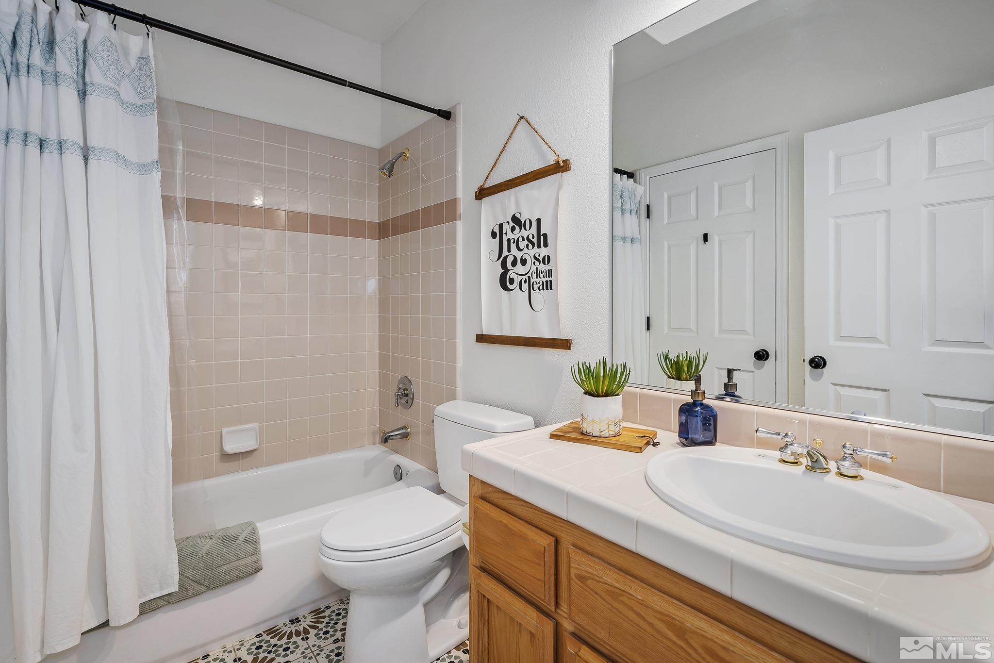 5016 East Albuquerque Road Reno, NV 89511 - Photo 19 of 38 a bathroom with a sink toilet and shower