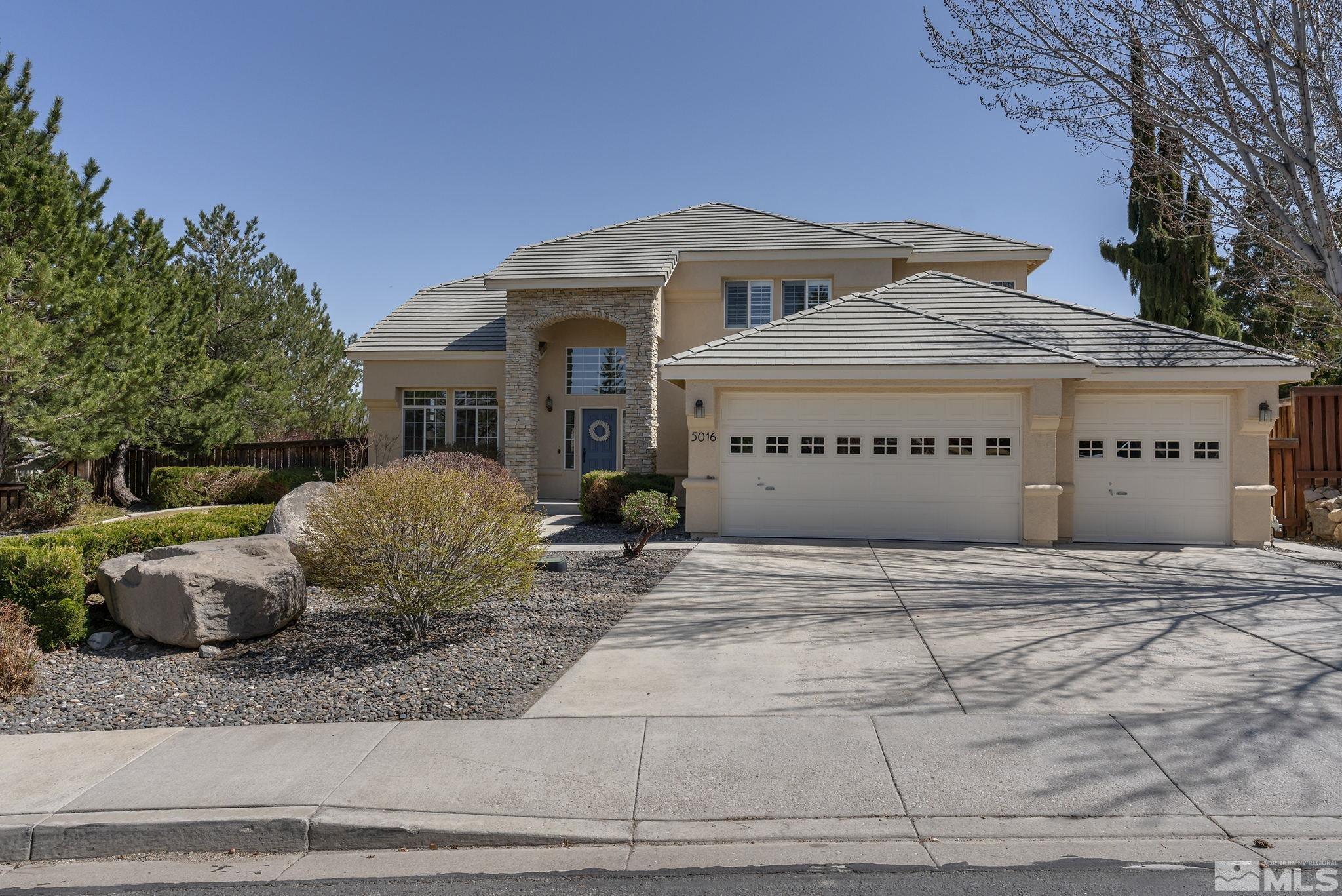 5016 East Albuquerque Road Reno, NV 89511 - Photo 2 of 38 a front view of a house with garage